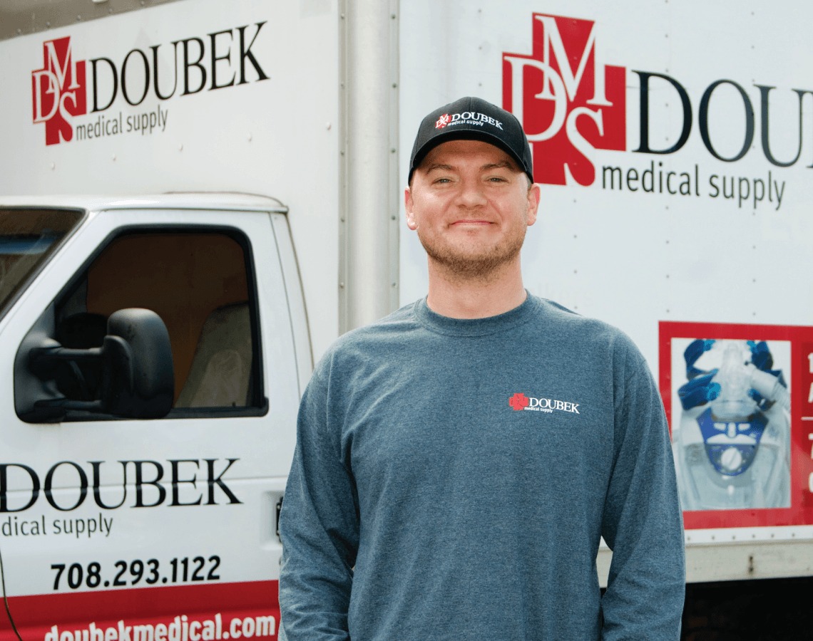 Dan smiling in front of delivery truck.