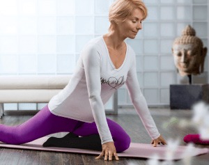 Woman doing yoga on the floor wearing compression socks