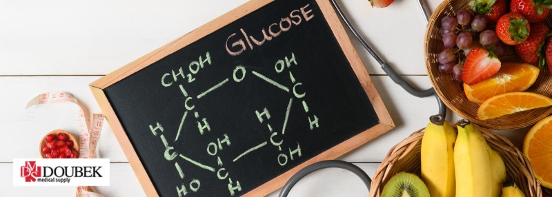 doubek-medical-supply-blood-sugar-blog-header Chalkboard with glucose breakdown written out and fruits in bowls around the board.