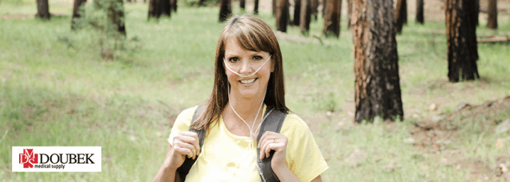 Woman outdoors with an oxygen pack on her back