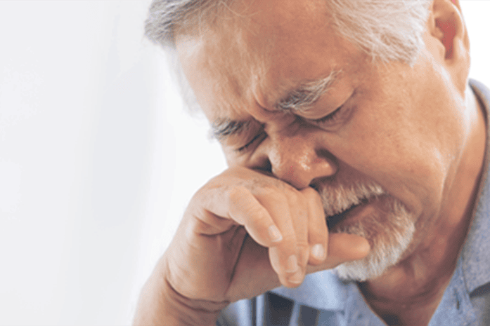 Man with allergies rubbing his nose