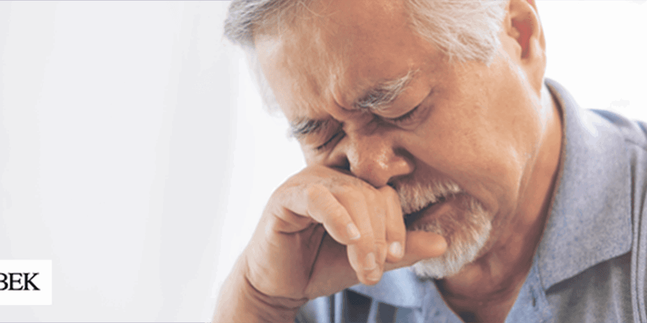 Man with allergies rubbing his nose