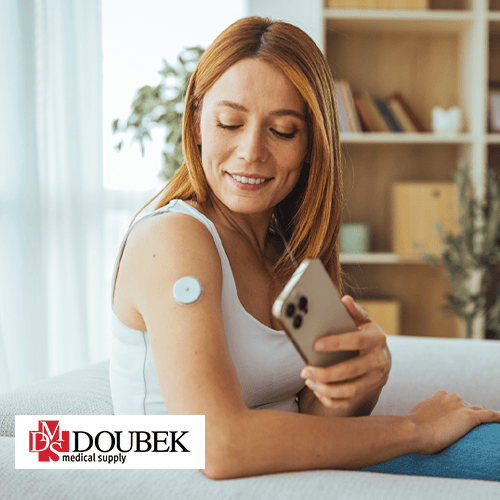 A woman using her phone to check her CGM